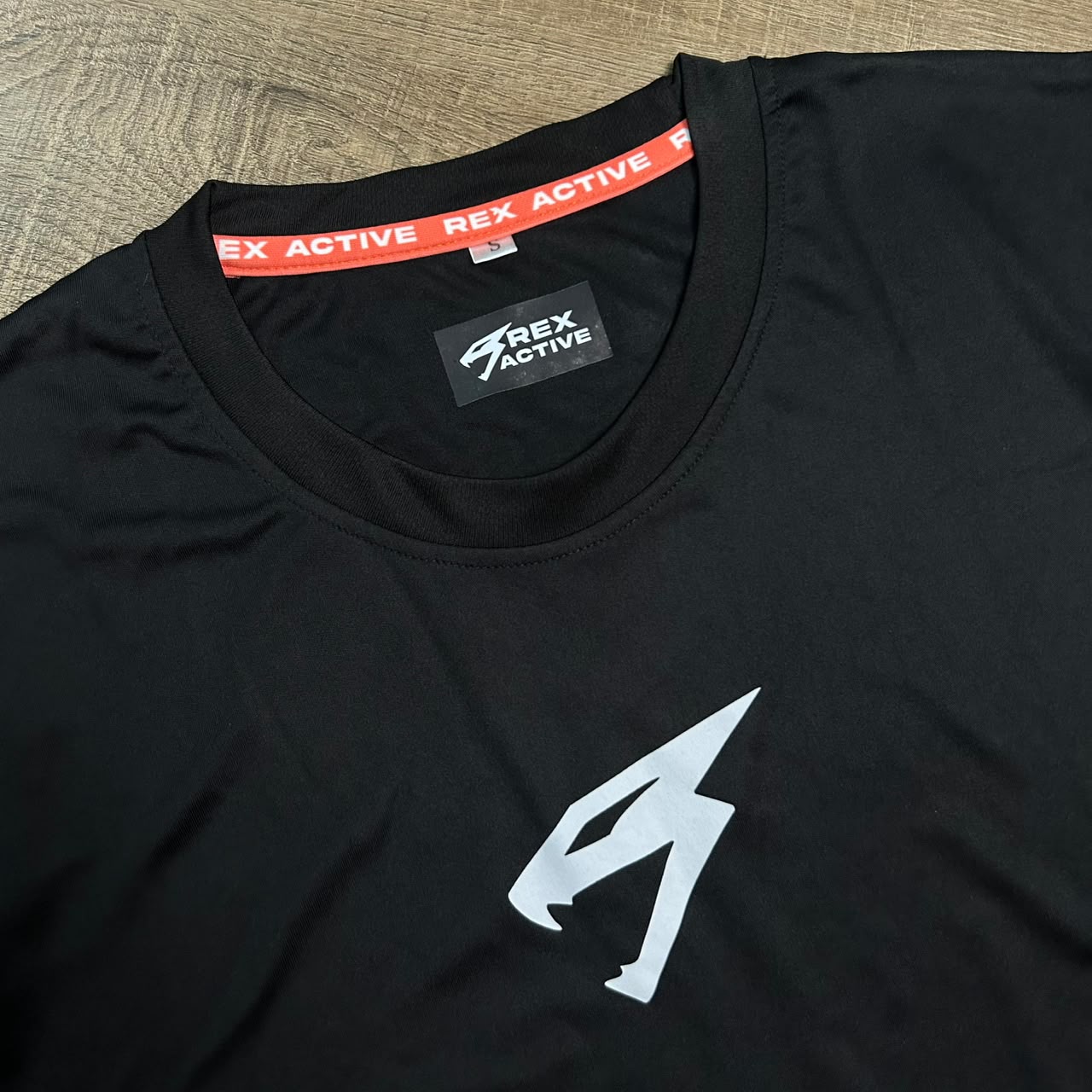 Red neck tape detail on the Rex Active Peak Tee